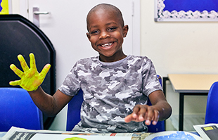 Boy painting indoors activity