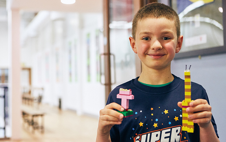 Young boy playing with LEGO