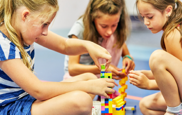 Children with indoor lego builds