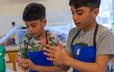 Boys cooking on cookery course