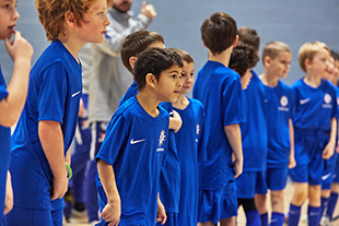 Children in Chelsea FC kits at football camp