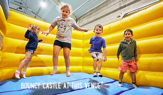 	Children bouncing on indoor bouncy castle