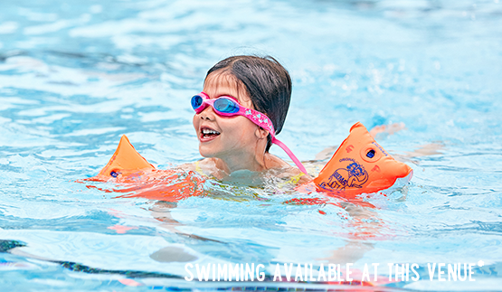 Child swimming with armbands and goggles