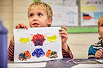 Child with painting at SuperCamps summer camp